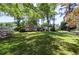 Single-story home featuring mature shade trees, manicured lawn, and beautiful flowerbeds at 1629 Anita Ne Pl, Atlanta, GA 30306