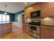 Kitchen with stainless steel range, granite counters, breakfast bar, and hardwood floors at 1629 Anita Ne Pl, Atlanta, GA 30306