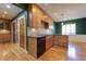 Bright kitchen with wood cabinets, granite counters, stainless appliances, hardwood floors, and breakfast bar at 1629 Anita Ne Pl, Atlanta, GA 30306