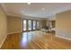 Spacious open-concept living room features gleaming hardwood floors and natural light from glass doors at 1629 Anita Ne Pl, Atlanta, GA 30306