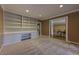 Spacious living room with built-in shelving, plush carpet, and an open doorway to the dining room at 1629 Anita Ne Pl, Atlanta, GA 30306