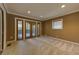 Spacious living room with plush carpet, recessed lighting, and French doors to a private outdoor patio at 1629 Anita Ne Pl, Atlanta, GA 30306