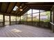 Inviting screened porch with wood floors, exposed beams and a ceiling fan at 1629 Anita Ne Pl, Atlanta, GA 30306