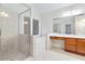 Bright bathroom features a glass shower, soaking tub, vanity, and a large window, offering a relaxing space at 2155 Washington Dr, Douglasville, GA 30135