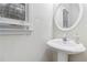 A well lit pedestal sink located in the bathroom at 2155 Washington Dr, Douglasville, GA 30135