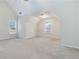 Spacious bedroom with a vaulted ceiling, two large windows providing natural light, and neutral carpeting at 2155 Washington Dr, Douglasville, GA 30135