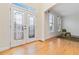 Bright foyer with glass paneled entry door and gleaming hardwood floors at 2155 Washington Dr, Douglasville, GA 30135