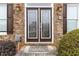 Elegant entryway with decorative glass doors and charming front porch details at 2155 Washington Dr, Douglasville, GA 30135