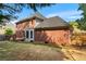 Beautiful backyard showcasing a brick home, deck, and lush green lawn at 2804 Livsey Woods Dr, Tucker, GA 30084