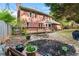 Landscaped backyard featuring a wooden deck, stone flowerbed, and a manicured lawn at 2804 Livsey Woods Dr, Tucker, GA 30084