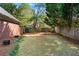 Fenced backyard with lawn and natural landscaping offers privacy and space for outdoor activities at 2804 Livsey Woods Dr, Tucker, GA 30084