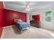 Bright bedroom featuring a ceiling fan, neutral carpet, and two windows at 2804 Livsey Woods Dr, Tucker, GA 30084