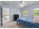 A carpeted bedroom features a light-blue wall and a small bed at 2804 Livsey Woods Dr, Tucker, GA 30084