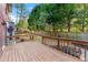 View of a wooden deck with railing overlooking a beautiful backyard with trees at 2804 Livsey Woods Dr, Tucker, GA 30084