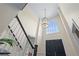 Elegant foyer showcasing a grand staircase, soaring ceilings, and a decorative chandelier at 2804 Livsey Woods Dr, Tucker, GA 30084