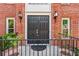Close-up of the elegant double front doors with decorative lanterns and wrought-iron railings at 2804 Livsey Woods Dr, Tucker, GA 30084