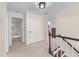 A hallway with access to multiple rooms featuring neutral walls and carpet flooring at 2804 Livsey Woods Dr, Tucker, GA 30084
