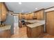 Well-appointed kitchen featuring wooden cabinets, granite countertops, and stainless steel appliances at 2804 Livsey Woods Dr, Tucker, GA 30084
