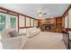 A spacious living room with a fireplace, built-in shelving, and a door to the backyard at 2804 Livsey Woods Dr, Tucker, GA 30084