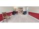 A comfortable living room with cream and red walls featuring a piano with carpet flooring at 2804 Livsey Woods Dr, Tucker, GA 30084