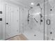 This large tile shower features black hardware and two shower heads at 2804 Livsey Woods Dr, Tucker, GA 30084