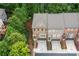 Aerial view of townhomes with brick facades, showing the roofs, driveways, and surrounding trees at 2528 Magnolia Ridge Dr, Marietta, GA 30067
