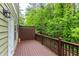 Cozy back deck with wood flooring, brown railing and lattice privacy screen, ideal for relaxing outdoors at 2528 Magnolia Ridge Dr, Marietta, GA 30067