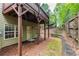 Back exterior of home with a door leading to a backyard area with retaining wall and a small grassy space at 2528 Magnolia Ridge Dr, Marietta, GA 30067