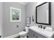 A lovely powder room featuring a modern vanity, neutral paint, attractive mirror, and fixtures at 2528 Magnolia Ridge Dr, Marietta, GA 30067