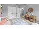 Bright Bedroom featuring a white crib, hardwood floors, white trim, and lots of storage space at 2528 Magnolia Ridge Dr, Marietta, GA 30067