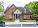 A brick clubhouse with a gated entrance, surrounded by landscaping and parking spaces at 2528 Magnolia Ridge Dr, Marietta, GA 30067