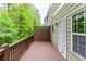 Outdoor deck with wood railing and a view of the trees and lush landscape at 2528 Magnolia Ridge Dr, Marietta, GA 30067