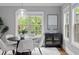 Cozy dining area featuring a modern light fixture, elegant furniture, and bright windows at 2528 Magnolia Ridge Dr, Marietta, GA 30067