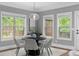 A cozy dining room with multiple windows providing natural light, a modern light fixture, and stylish decor at 2528 Magnolia Ridge Dr, Marietta, GA 30067