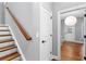 Foyer with wooden stairs and a view into an adjacent room with natural light at 2528 Magnolia Ridge Dr, Marietta, GA 30067