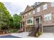 Beautiful brick townhome exterior with attached garages, and manicured landscaping at 2528 Magnolia Ridge Dr, Marietta, GA 30067