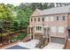 Townhome exterior featuring brick and stone facade, attached garages, and well-maintained landscaping at 2528 Magnolia Ridge Dr, Marietta, GA 30067