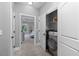 A convenient laundry closet features a modern washer inside of folding doors at 2528 Magnolia Ridge Dr, Marietta, GA 30067