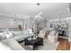 An open concept living room with modern decor and adjacent dining area and kitchen at 2528 Magnolia Ridge Dr, Marietta, GA 30067