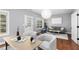 Inviting living room with hardwood floors, a stylish couch, and ample natural light at 2528 Magnolia Ridge Dr, Marietta, GA 30067