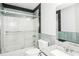 Tiled bathroom with a sliding glass shower door, commode, vanity and mirror at 6331 Wedgeview Dr, Tucker, GA 30084