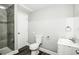 Bathroom featuring a tiled walk-in shower, commode, sink, and sleek finishes at 6331 Wedgeview Dr, Tucker, GA 30084
