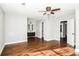 Spacious bedroom showcasing wood floors, modern ceiling fan, and doorways to the bathroom at 6331 Wedgeview Dr, Tucker, GA 30084