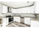 Updated kitchen showcasing white cabinets, stainless steel appliances, and granite countertops at 6331 Wedgeview Dr, Tucker, GA 30084