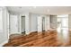 Open-plan living room boasting hardwood floors, grey walls, and hallway access to a bathroom at 6331 Wedgeview Dr, Tucker, GA 30084