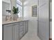 Elegant bathroom with dual sinks, white quartz countertops, and gray cabinets at 190 Rolison Way, Fayetteville, GA 30214