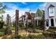 An outdoor seating and garden area with a variety of plants and trellises sits amongst beautiful single-Gathering homes at 190 Rolison Way, Fayetteville, GA 30214