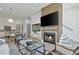 Open-concept living room features a fireplace, hardwood floors, and seamless transition to dining area at 190 Rolison Way, Fayetteville, GA 30214