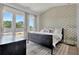Serene bedroom with private balcony, patterned wallpaper, and soft natural light at 190 Rolison Way, Fayetteville, GA 30214