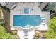 Aerial view of backyard featuring a pool, hot tub, patio, and lush landscaping at 854 Club Moss Ct, Marietta, GA 30068